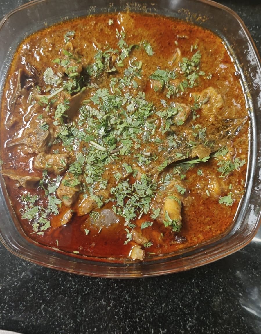Mutton curry topped with fresh coriander