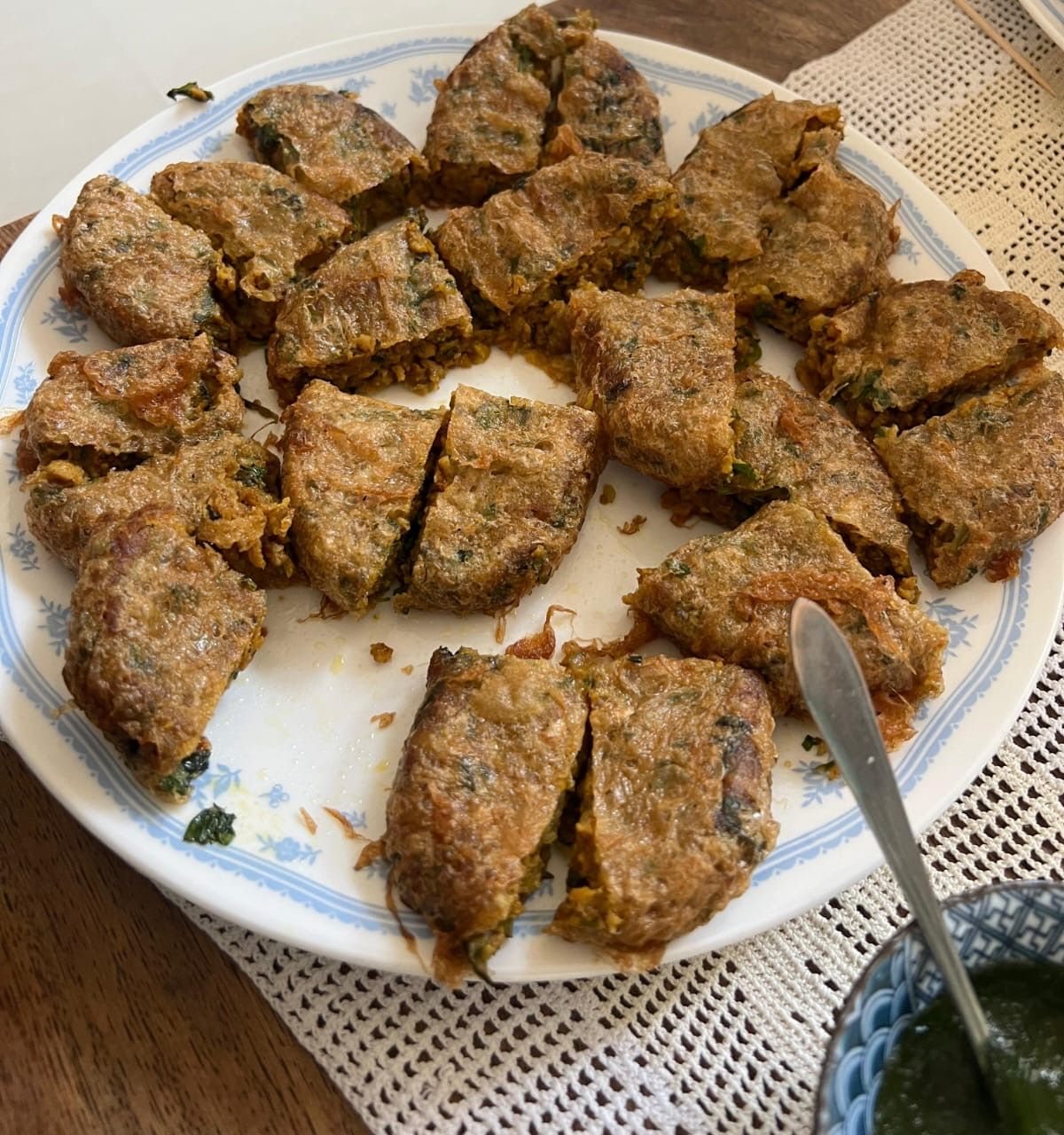 A plate of spiced stuffed rolls cut into pieces